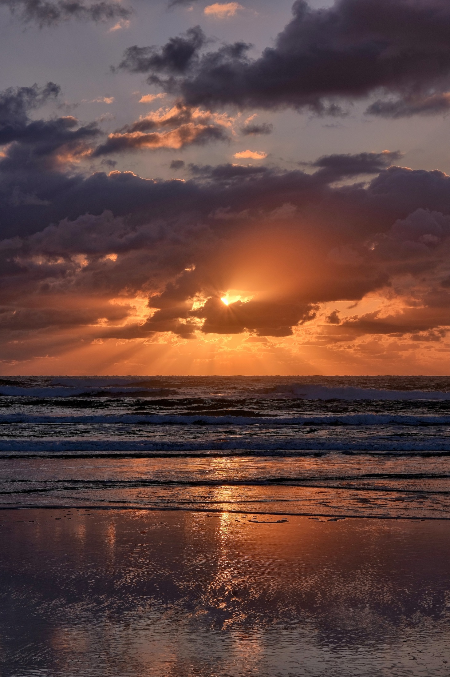 Sunrise breaking through clouds over Kingscliff Beach